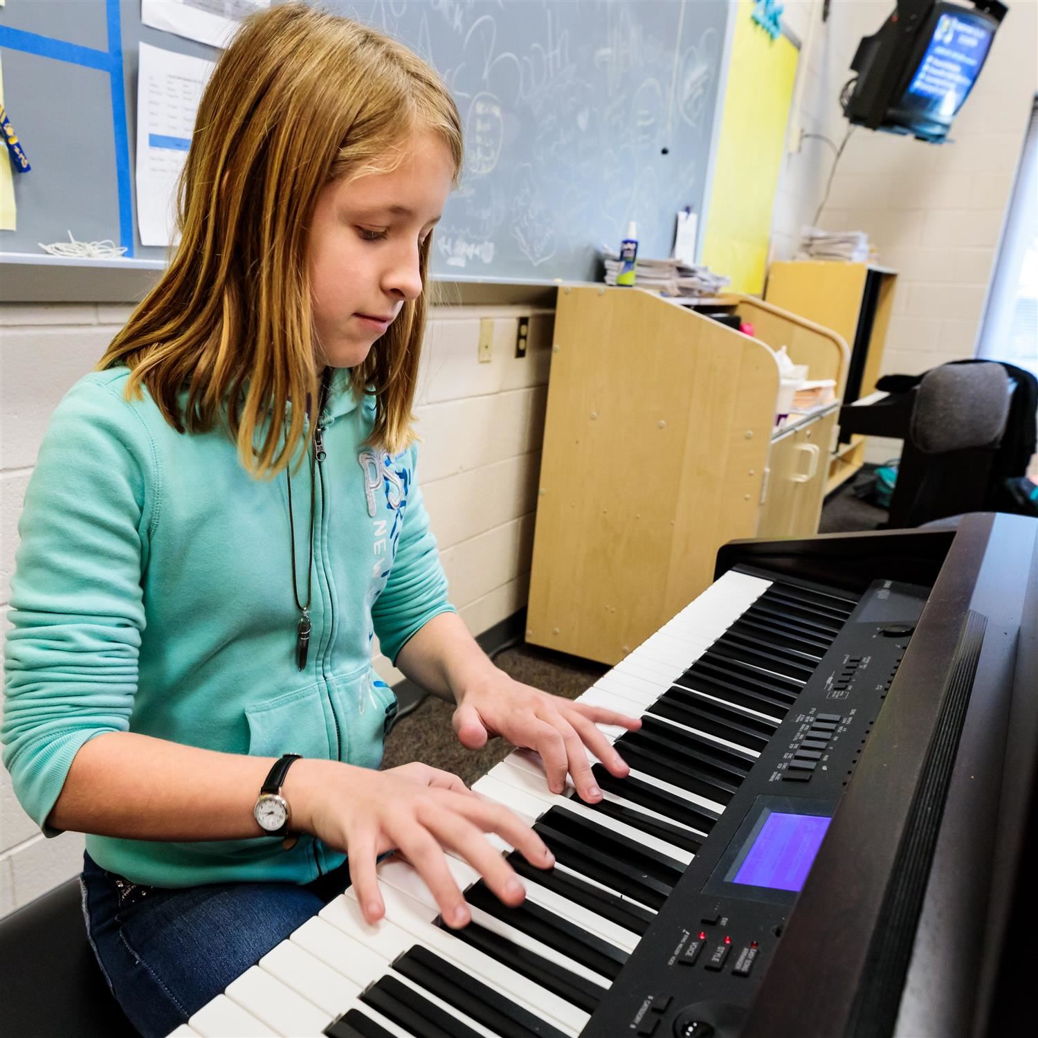  female student playing an electric piano